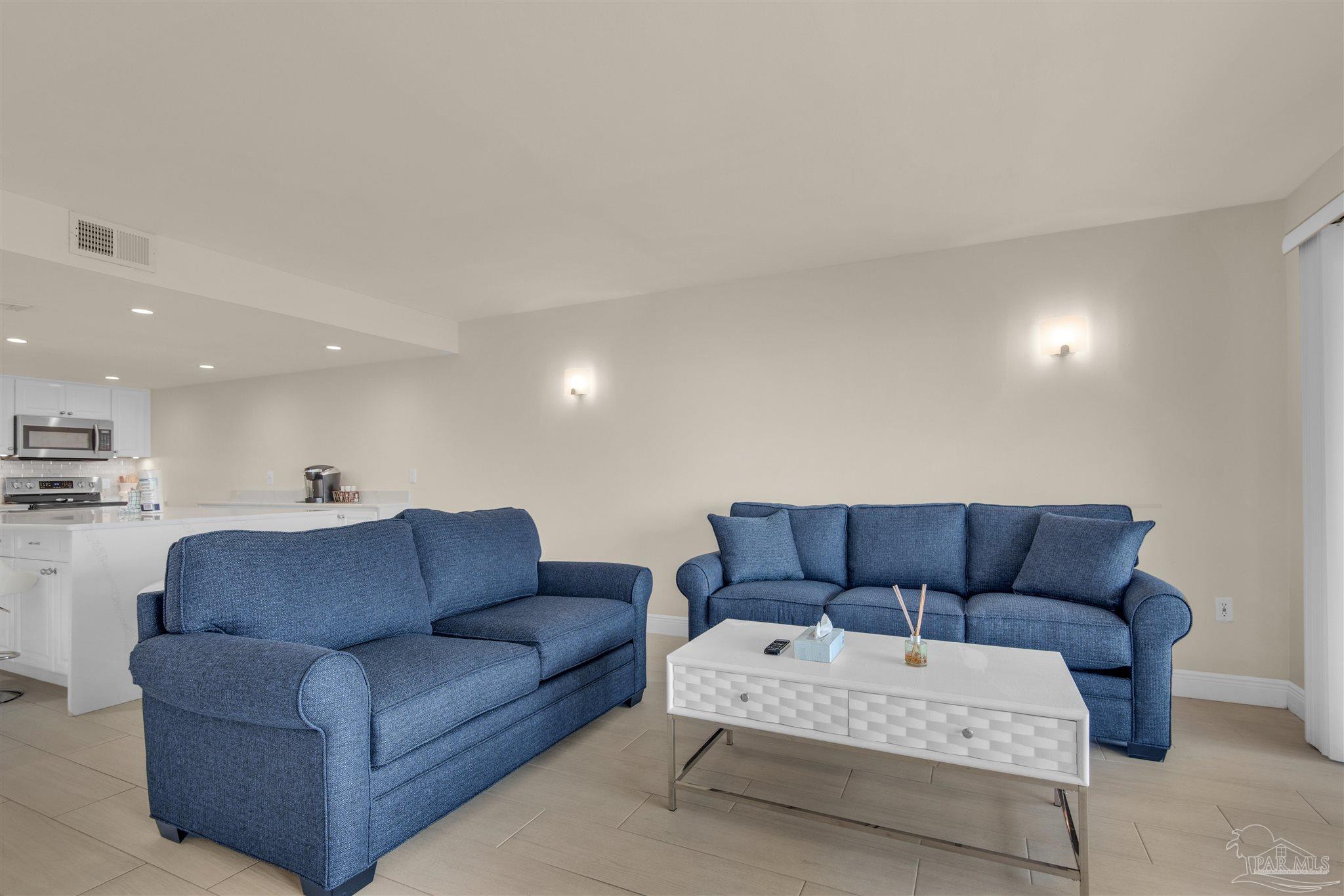 900 Fort Pickens Road, Unit 425 Pensacola Beach, FL 32561 - Photo 9 of 47 a living room with furniture and a couch