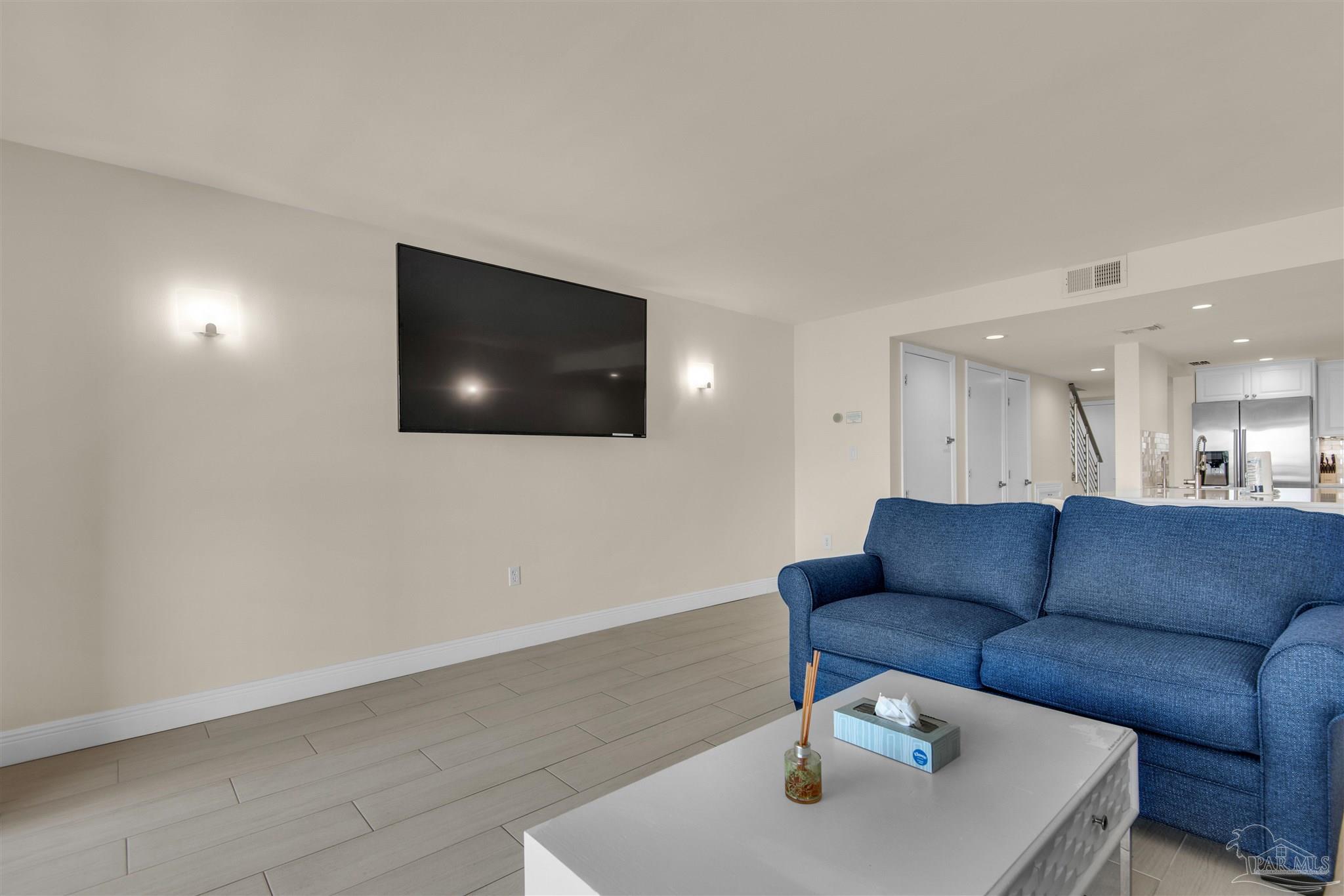 900 Fort Pickens Road, Unit 425 Pensacola Beach, FL 32561 - Photo 10 of 47 a living room with furniture and a flat screen tv