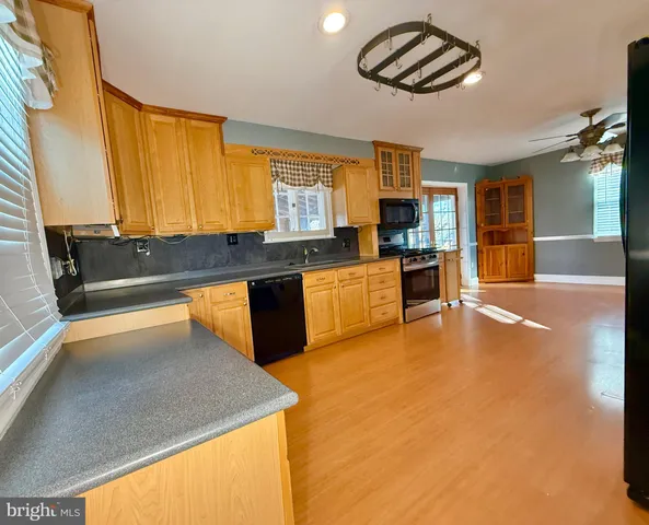 a kitchen with stainless steel appliances granite countertop a sink and a stove