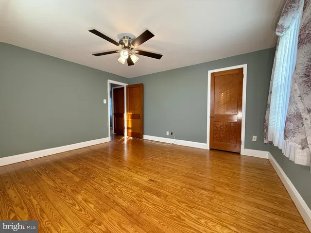 a view of a room with wooden floor