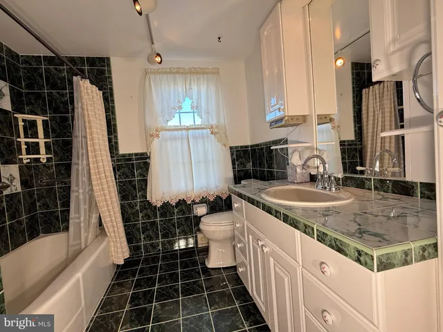 a bathroom with double vanity and a shower