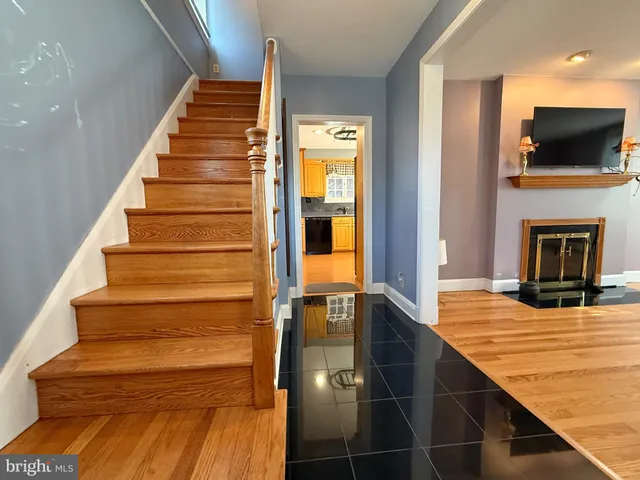a view of entryway and hall with wooden floor