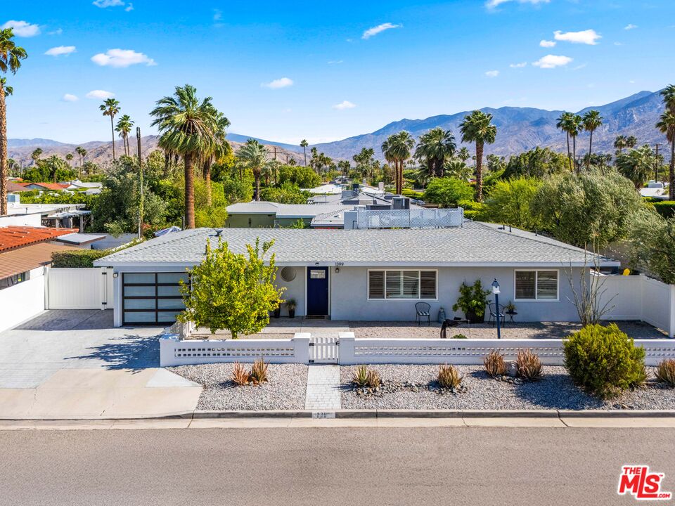 1399 Tamarisk Road Palm Springs, CA 92262 - Photo 2 of 28 a front view of a house with a garden and mountain view