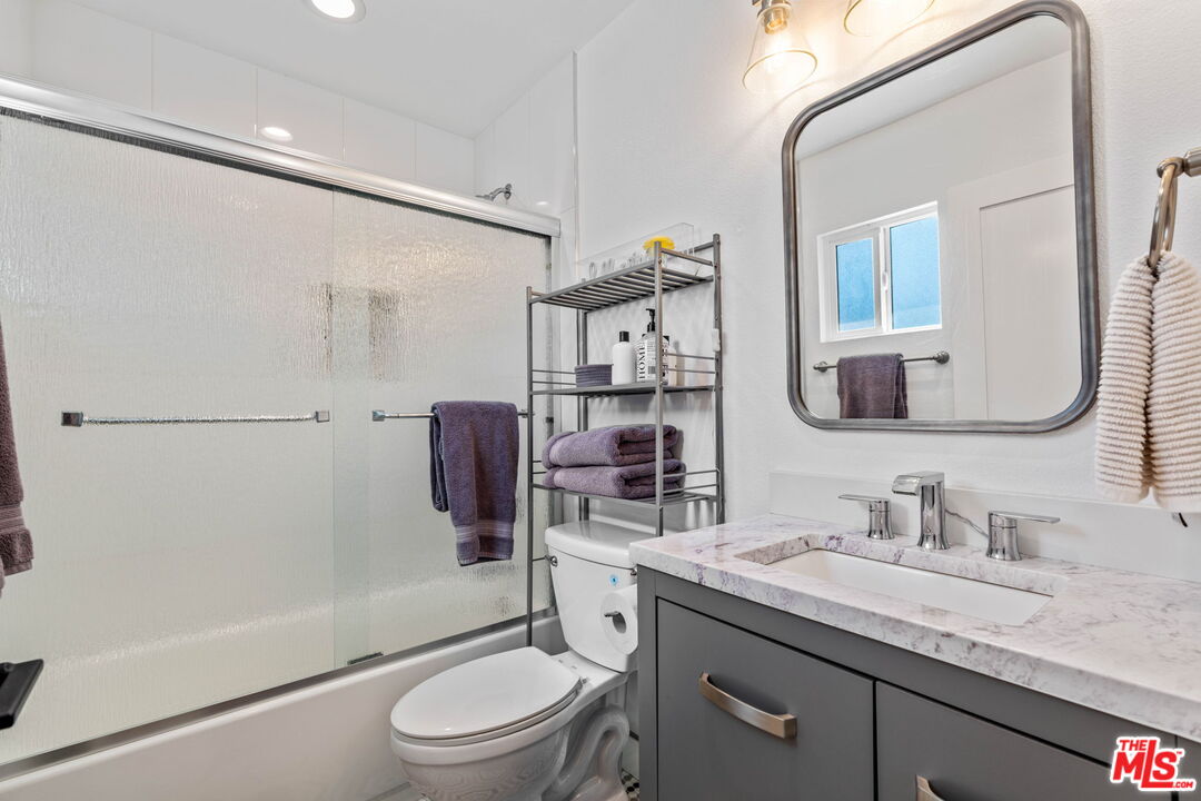 1399 Tamarisk Road Palm Springs, CA 92262 - Photo 21 of 28 a bathroom with a granite countertop sink toilet and shower