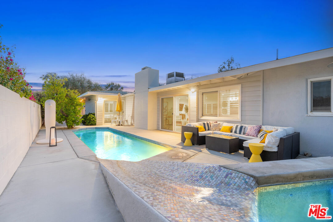 1399 Tamarisk Road Palm Springs, CA 92262 - Photo 24 of 28 a view of a house with swimming pool