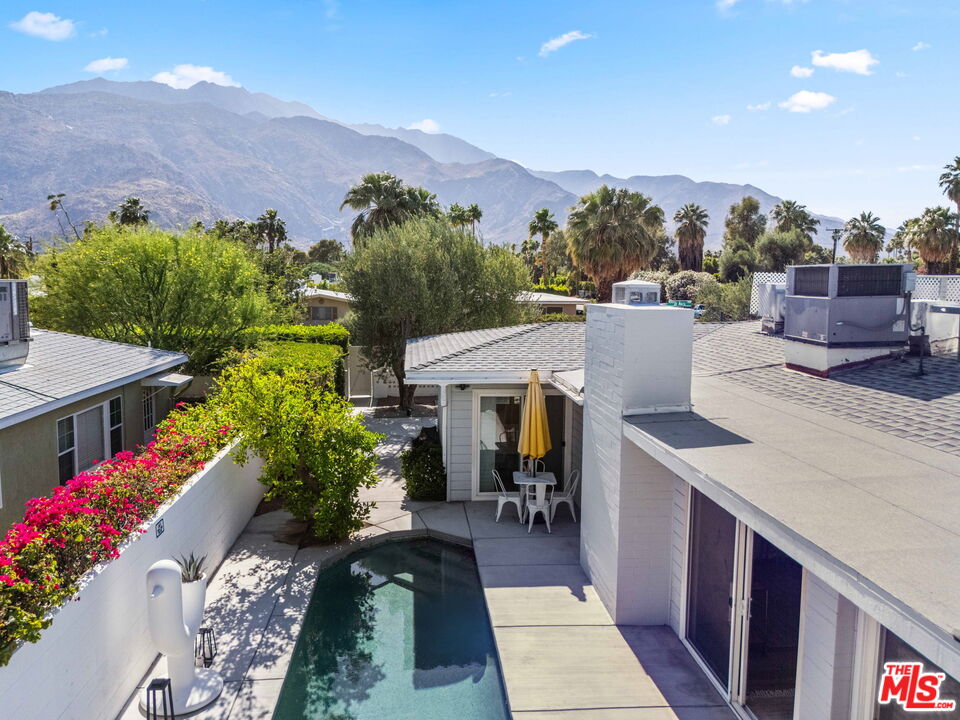 1399 Tamarisk Road Palm Springs, CA 92262 - Photo 27 of 28 a view of a patio with table and chairs and potted plants