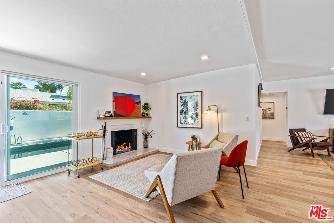 1399 Tamarisk Road Palm Springs, CA 92262 - Photo 5 of 28 a living room with furniture fireplace and window
