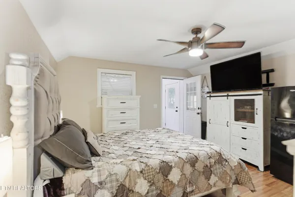 a bedroom with a bed and flat screen tv