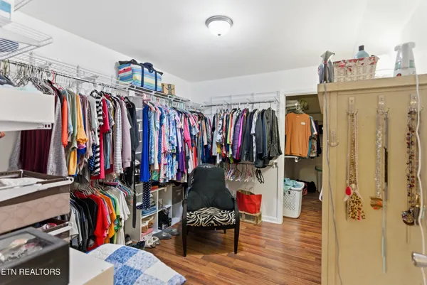 a view of walk in closet with clothes and shoes