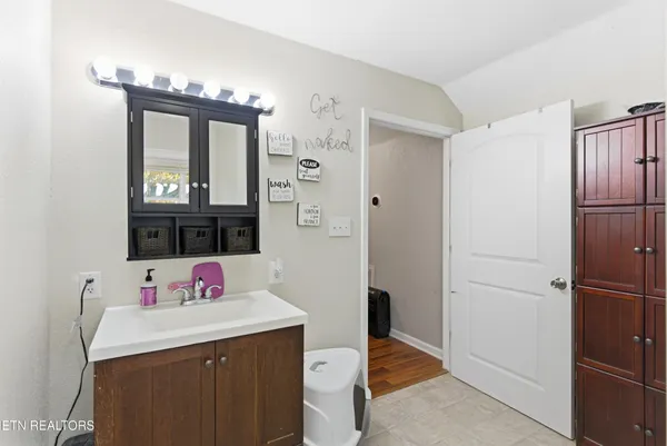 a kitchen with a refrigerator and a sink