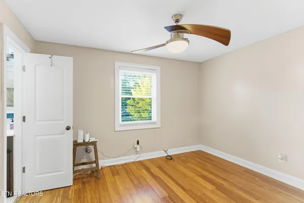 a big room with wooden floor and windows