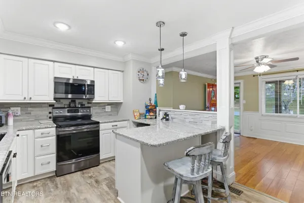 a kitchen with a center island appliances and cabinets