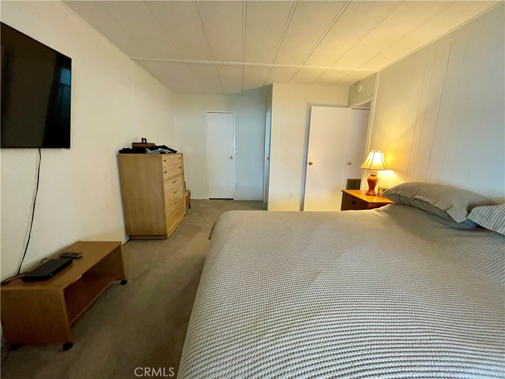 31130 South General Kearny Road, Unit 145 Temecula, CA 92591 - Photo 16 of 27 a bedroom with a bed and a flat screen tv