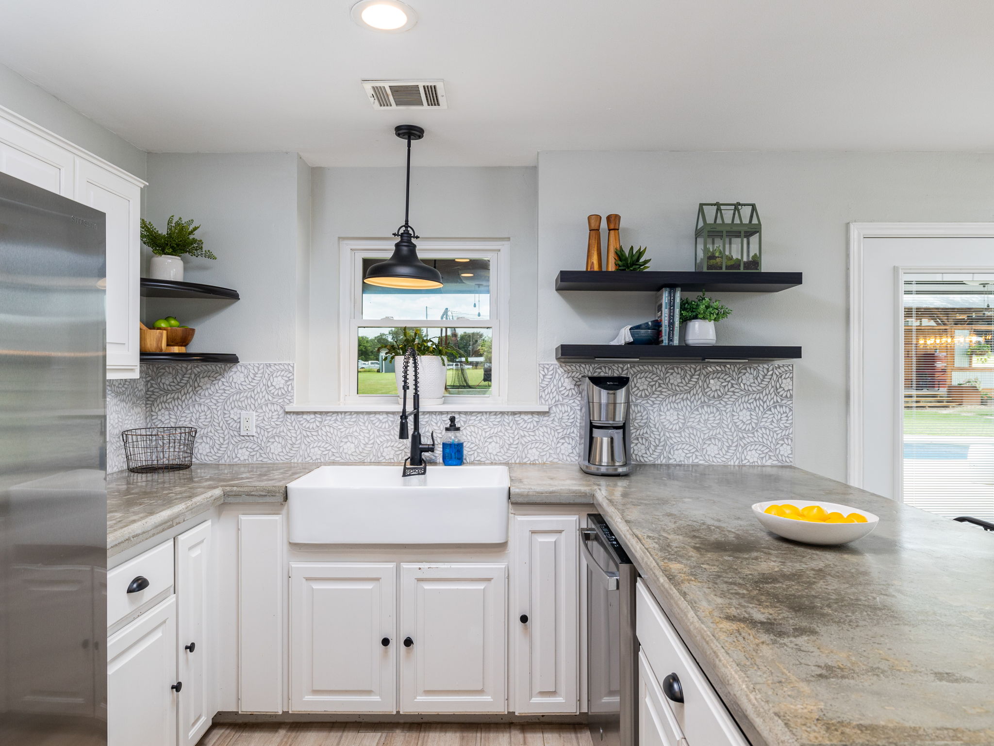 3001 County Road 255 Georgetown, TX 78633 - Photo 14 of 35 A well-lit kitchen with concrete counters and a deep farmhouse sink offers both style and function.