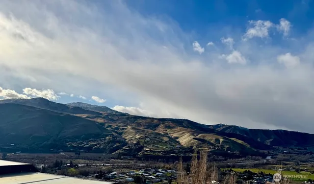 a living room with furniture a large window and a fireplace
