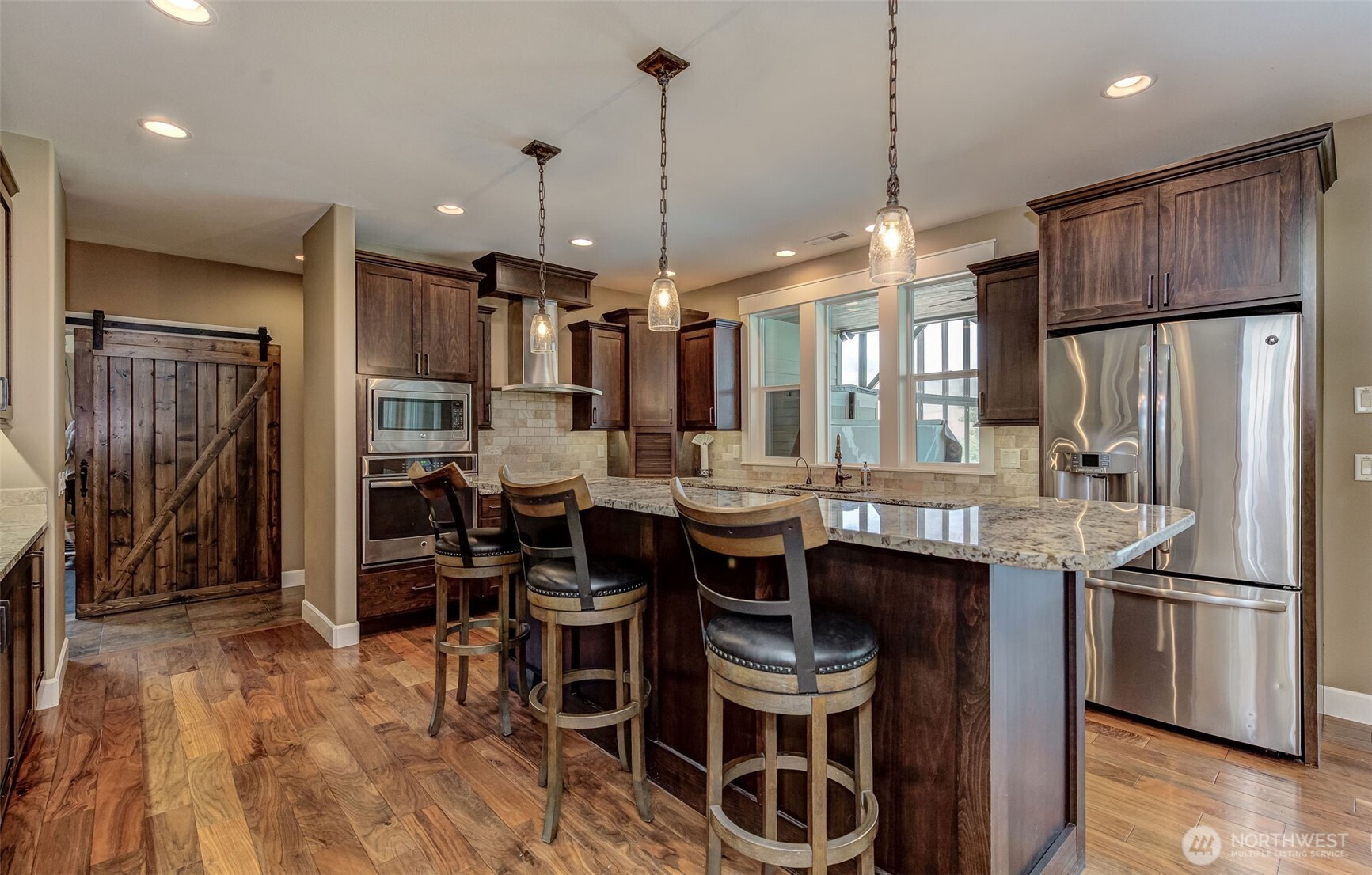 1400 Westpoint Place Wenatchee, WA 98801 - Photo 7 of 36 a kitchen with stainless steel appliances a dining table chairs sink and cabinets