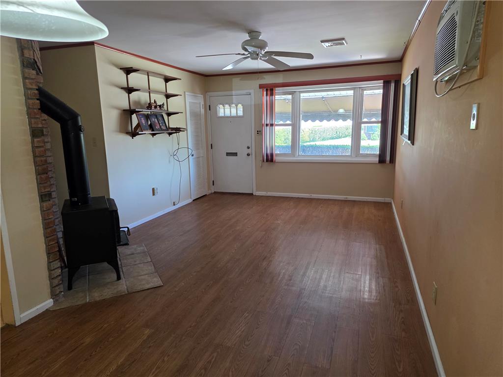 3134 Roxford Road Allentown, PA 18103 - Photo 13 of 34 A welcoming interior offers a free-standing stove, laminate flooring, and ample natural light from the large windows.