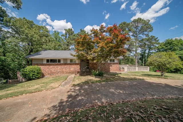 a front view of a house with a yard and a garage