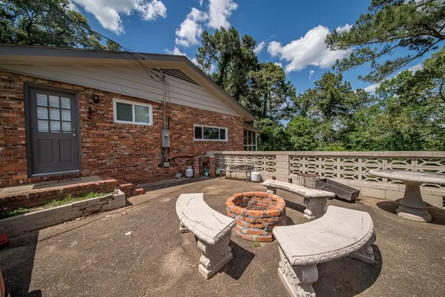 a view of a patio with chairs and potted plants