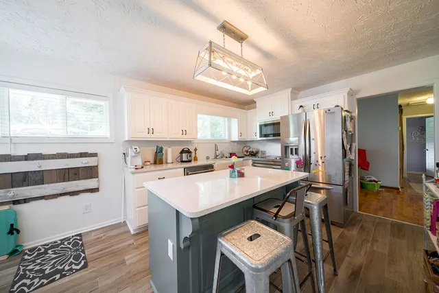 a kitchen with a sink appliances and cabinets