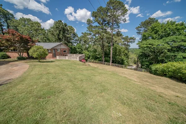 a view of a house with a yard and garage