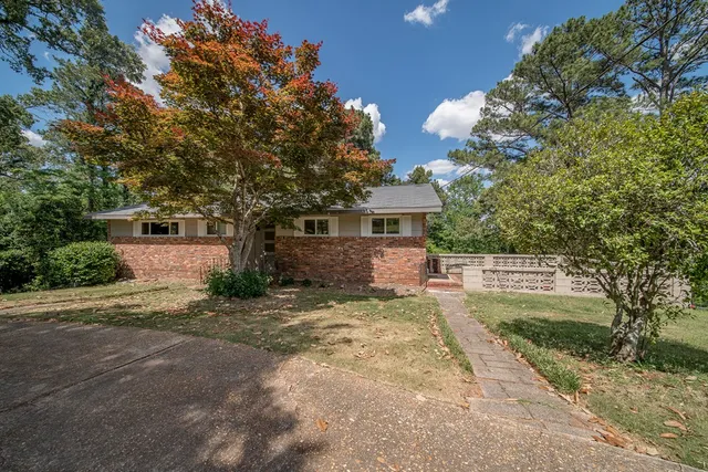 a front view of a house with a yard and a garage