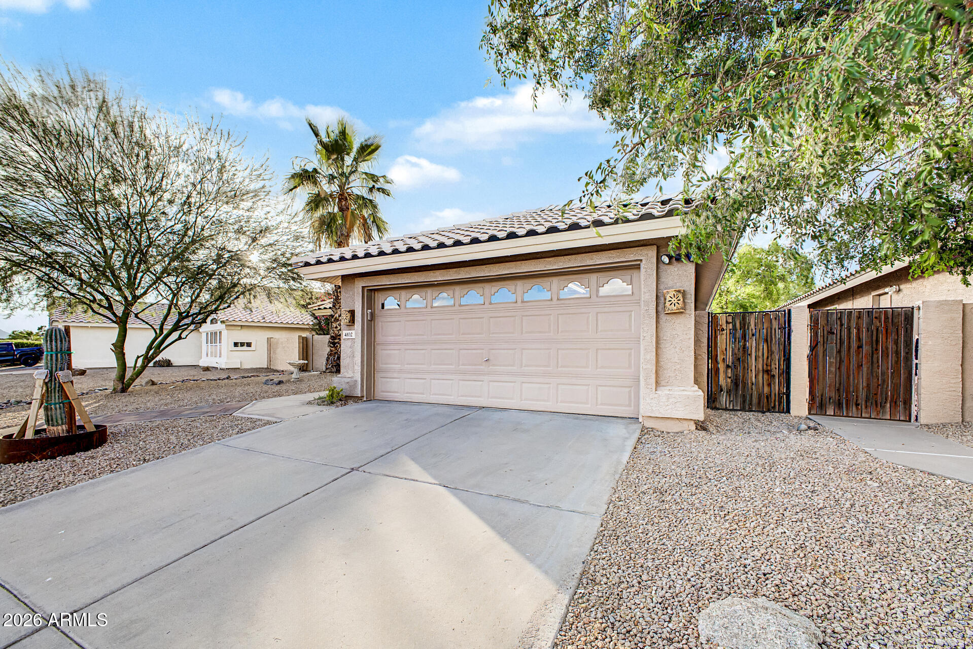 4102 East Rock Wren Road Phoenix, AZ 85044 - Photo 4 of 25 a front view of a house with a garage