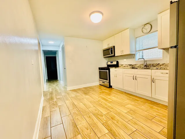 a kitchen with stainless steel appliances granite countertop a sink and cabinets