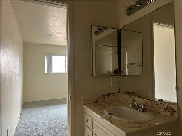 a bathroom with a granite countertop sink and mirror