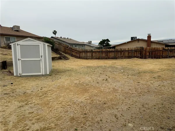 a view of a house with backyard and deck