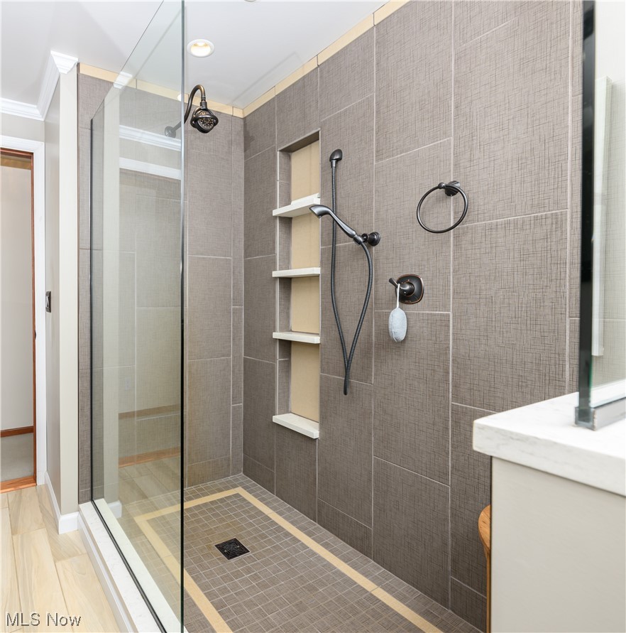 5304 Sibila Road Northwest Canton, OH 44718 - Photo 22 of 29 Bathroom with tiled shower, ornamental molding, and wood-type flooring