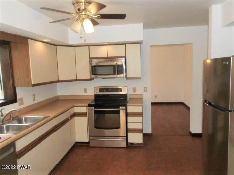 126 Maple Ridge Drive Hawley, PA 18428 - Photo 16 of 40 a kitchen with a sink appliances and cabinets