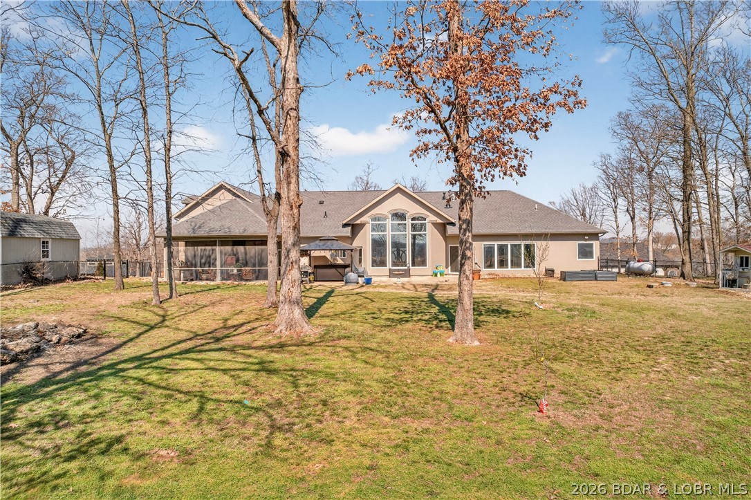 890 Anemone Road Lake Ozark, MO 65049 - Photo 53 of 63 Back of home-large, flat, fenced back yard