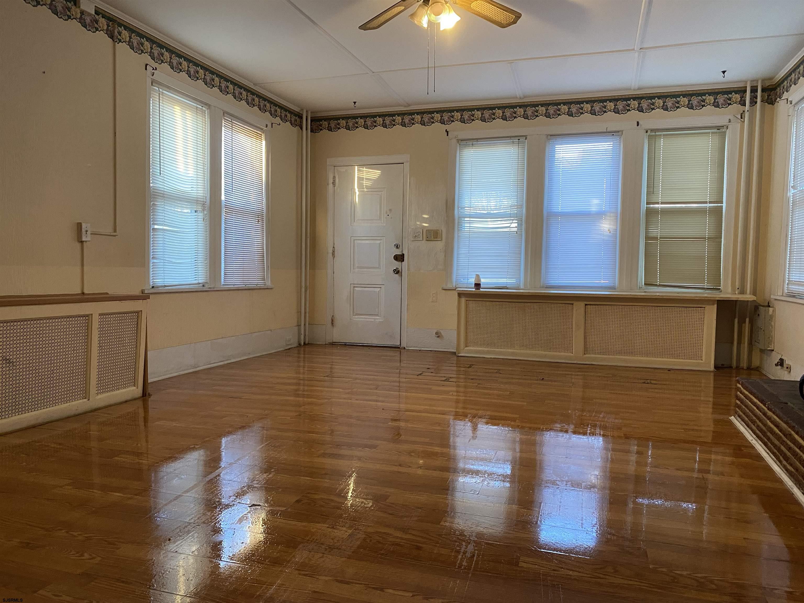 137 West Edgewater Avenue Pleasantville, NJ 08232 - Photo 5 of 36 a view of empty room with wooden floor and fan