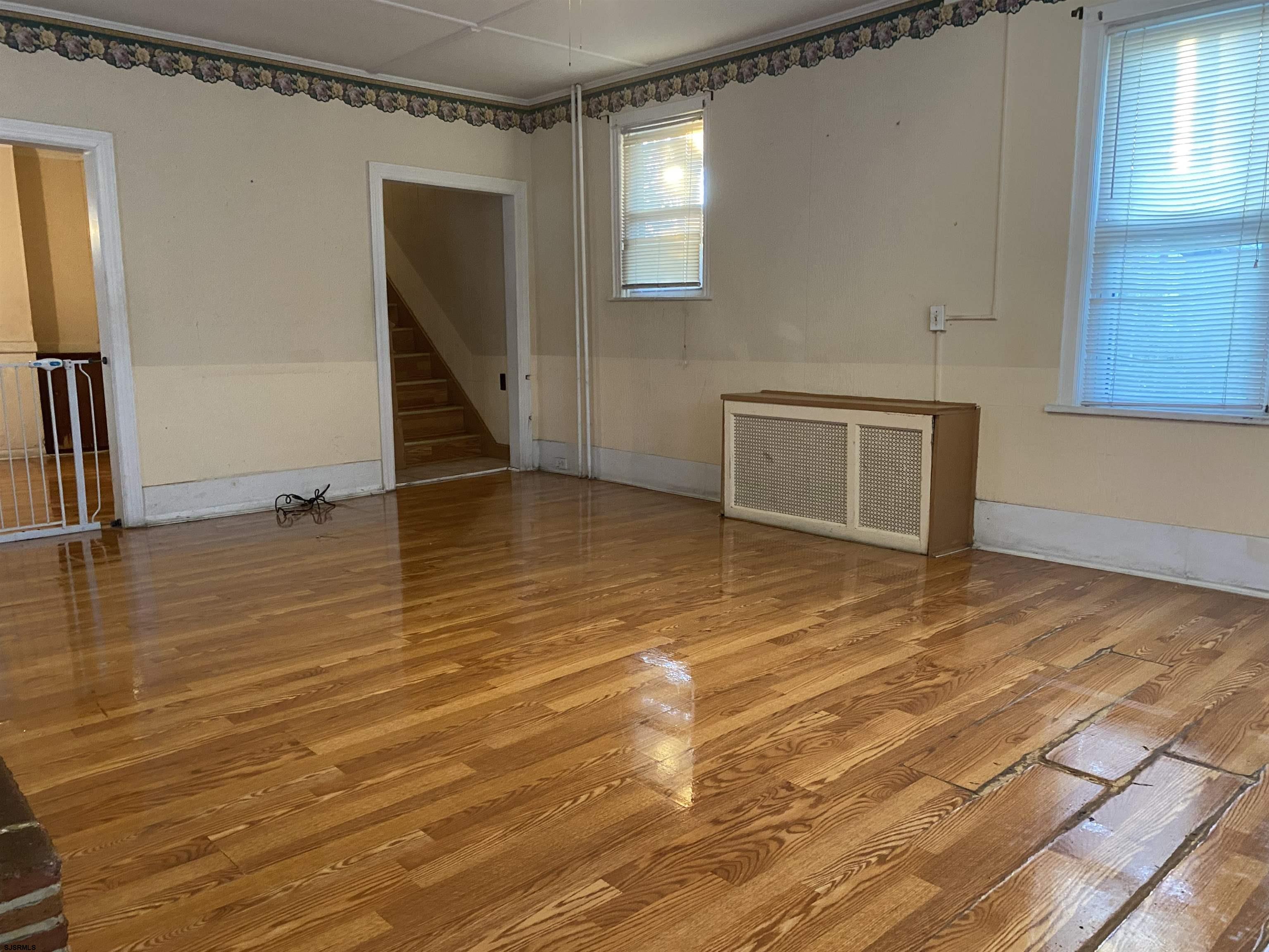 137 West Edgewater Avenue Pleasantville, NJ 08232 - Photo 6 of 36 a view of an empty room with wooden floor and a window