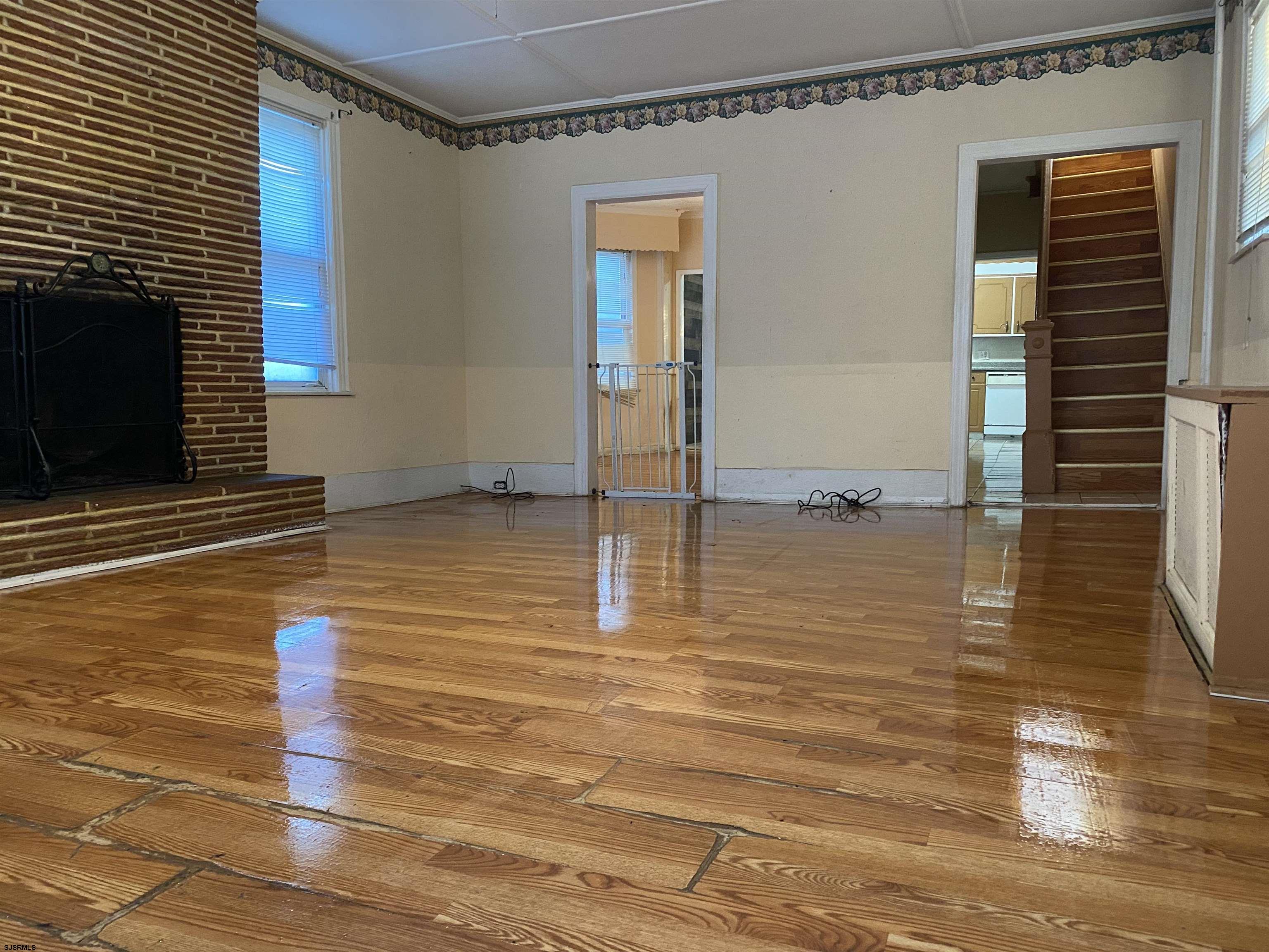 137 West Edgewater Avenue Pleasantville, NJ 08232 - Photo 7 of 36 a view of a livingroom with wooden floor and a fireplace