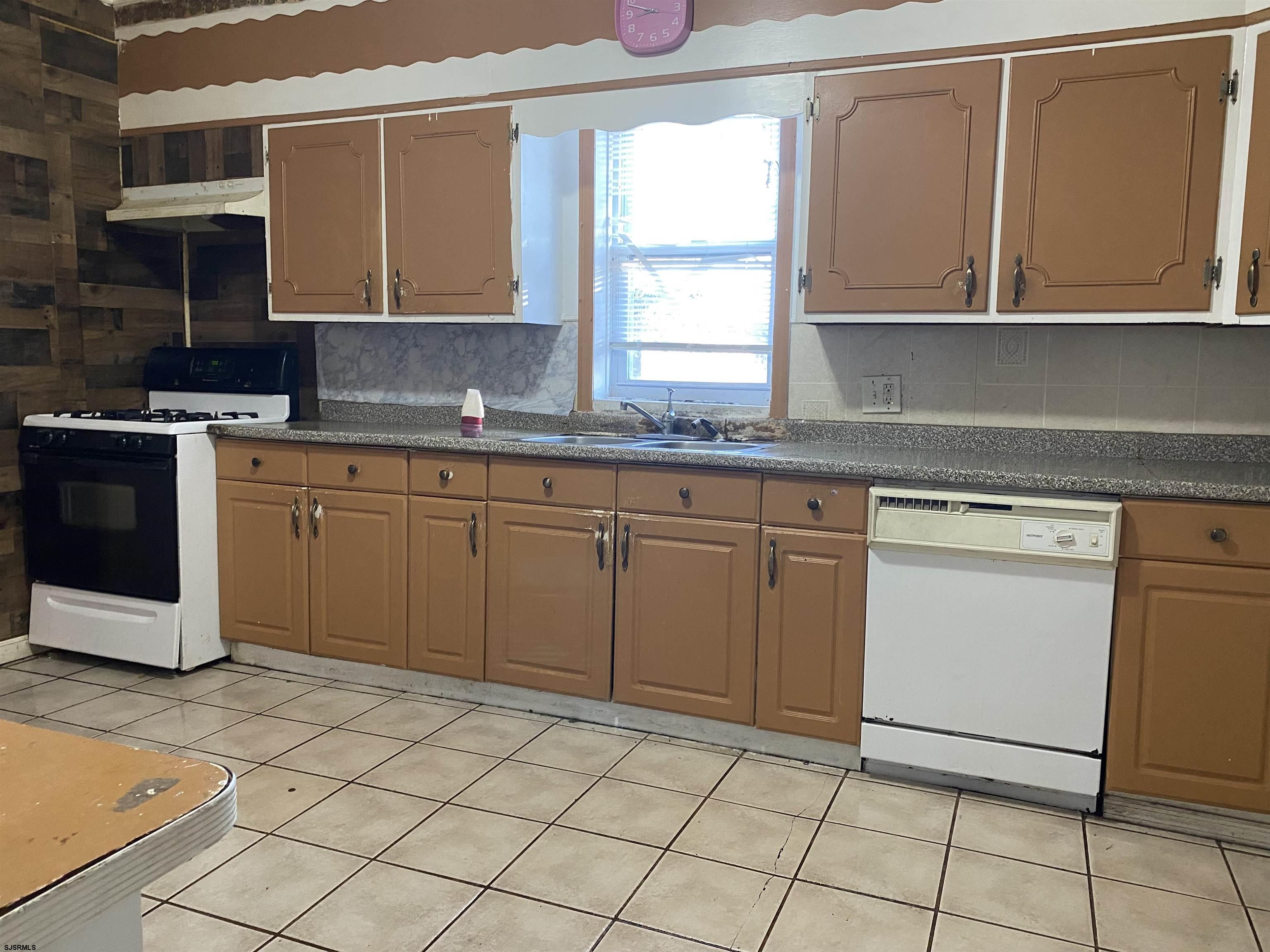 137 West Edgewater Avenue Pleasantville, NJ 08232 - Photo 10 of 36 a kitchen with cabinets and white appliances
