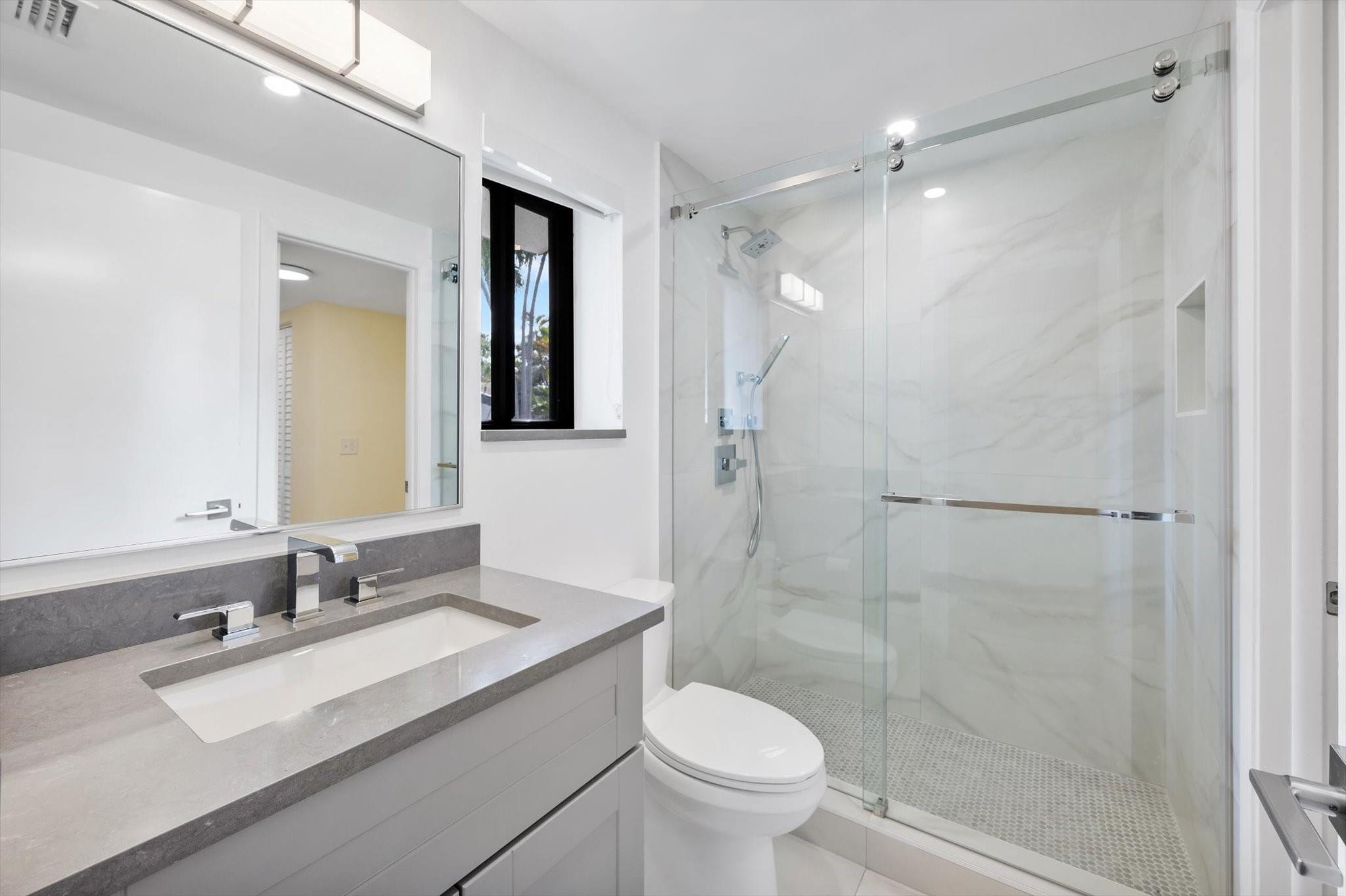 19986 Northeast 5th Court, Unit 4D Miami, FL 33179 - Photo 14 of 46 a bathroom with a sink toilet and shower