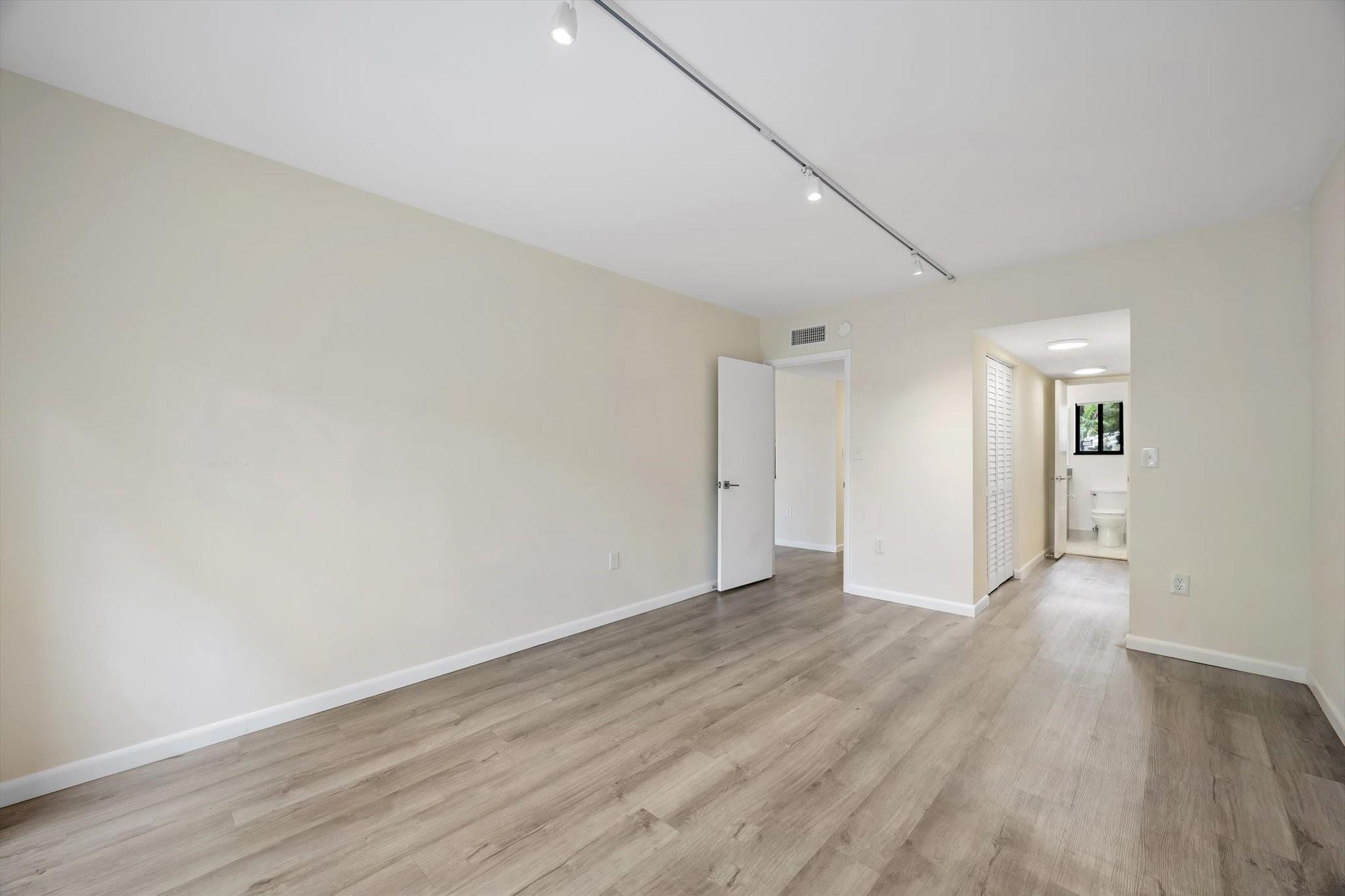 19986 Northeast 5th Court, Unit 4D Miami, FL 33179 - Photo 15 of 46 a view of an empty room with wooden floor