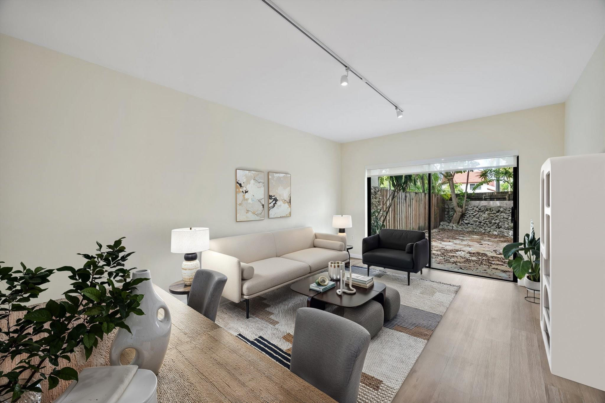 19986 Northeast 5th Court, Unit 4D Miami, FL 33179 - Photo 16 of 46 a living room with furniture and a potted plant