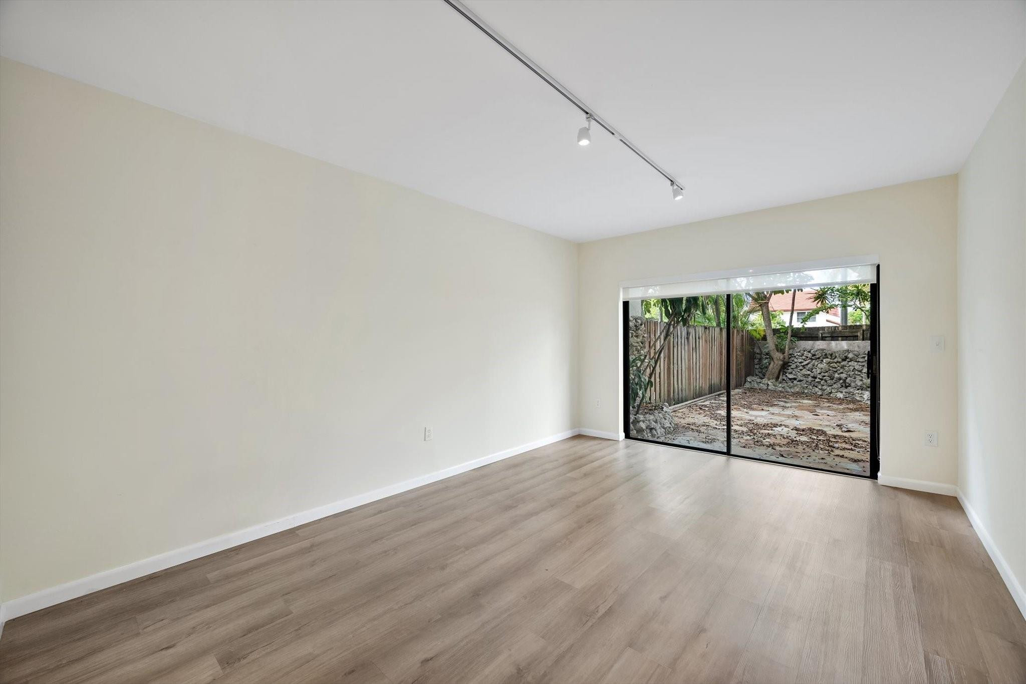 19986 Northeast 5th Court, Unit 4D Miami, FL 33179 - Photo 17 of 46 wooden floor in an empty room with a window