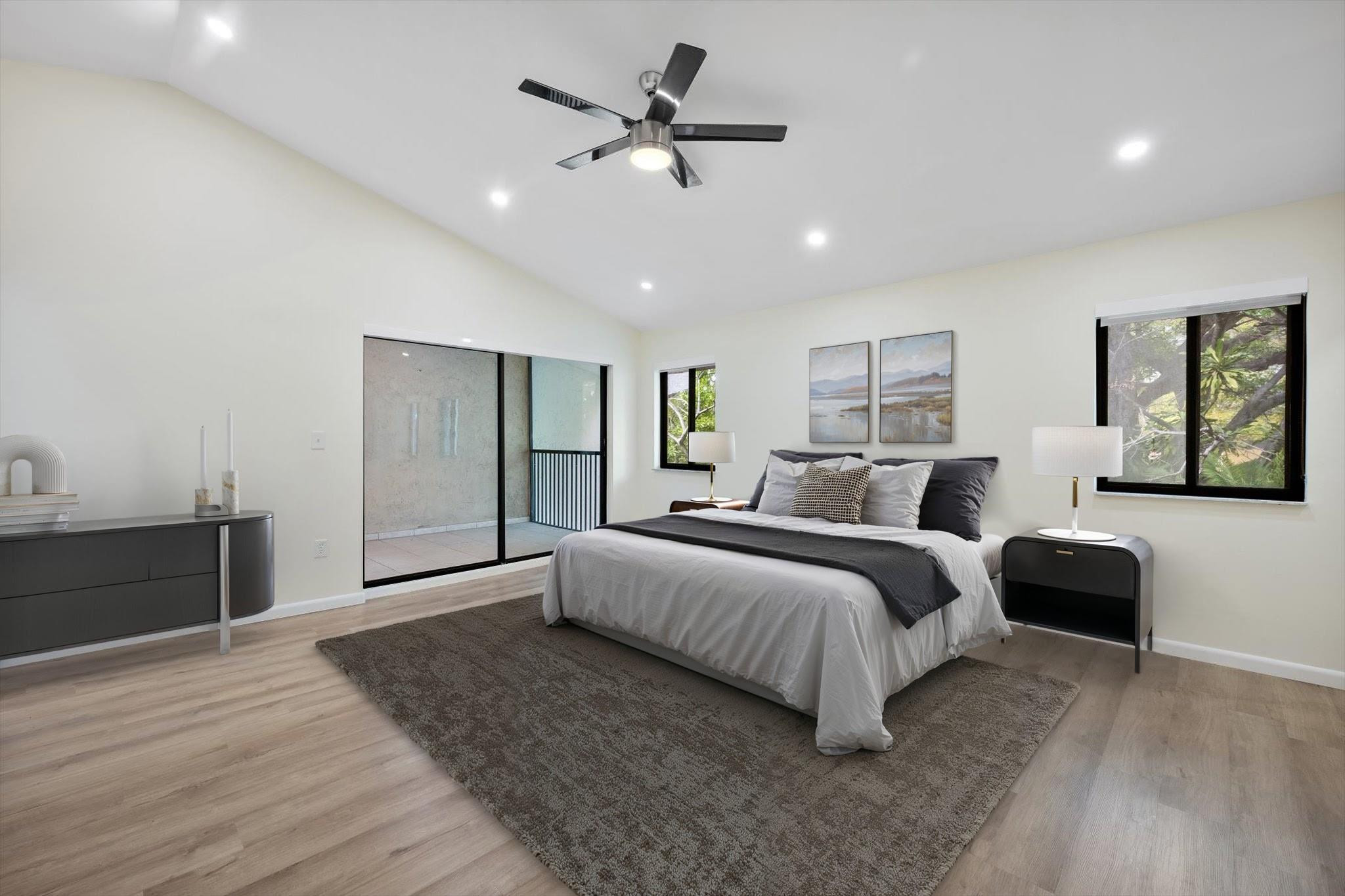 19986 Northeast 5th Court, Unit 4D Miami, FL 33179 - Photo 19 of 46 a spacious bedroom with a large bed and a chandelier