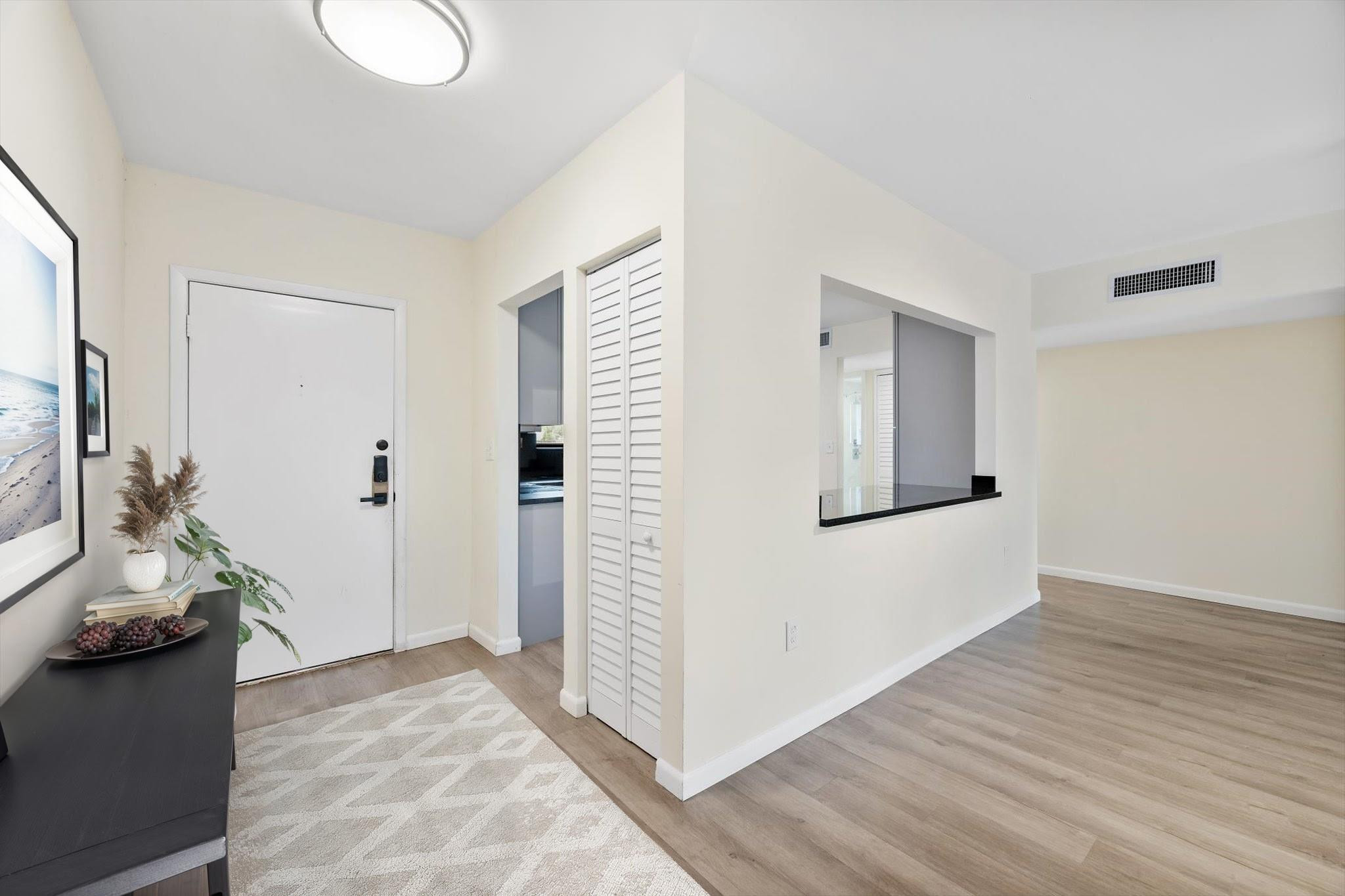 19986 Northeast 5th Court, Unit 4D Miami, FL 33179 - Photo 2 of 46 a view of a livingroom with wooden floor and a hallway