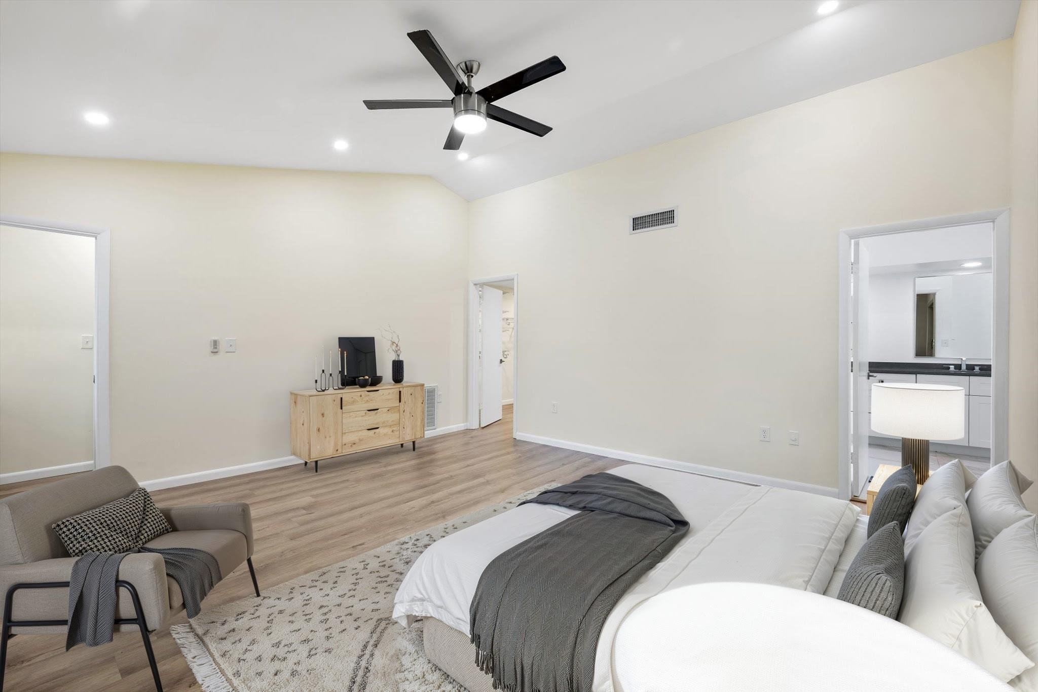 19986 Northeast 5th Court, Unit 4D Miami, FL 33179 - Photo 21 of 46 a bedroom with a bed a couch and a chandelier