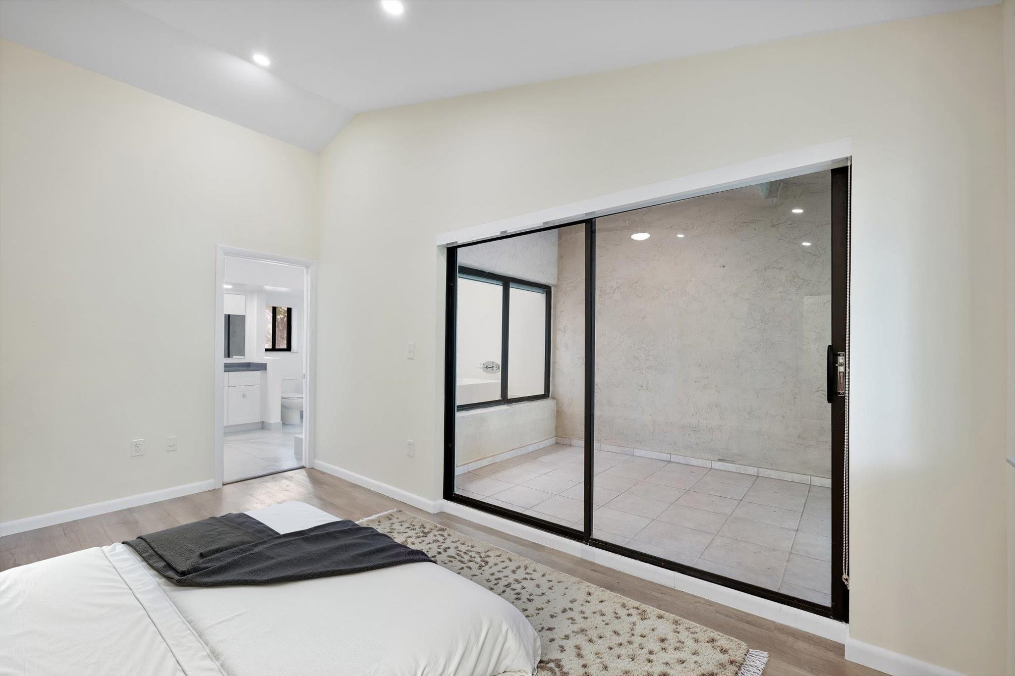 19986 Northeast 5th Court, Unit 4D Miami, FL 33179 - Photo 22 of 46 a bedroom with a bed and cabinets