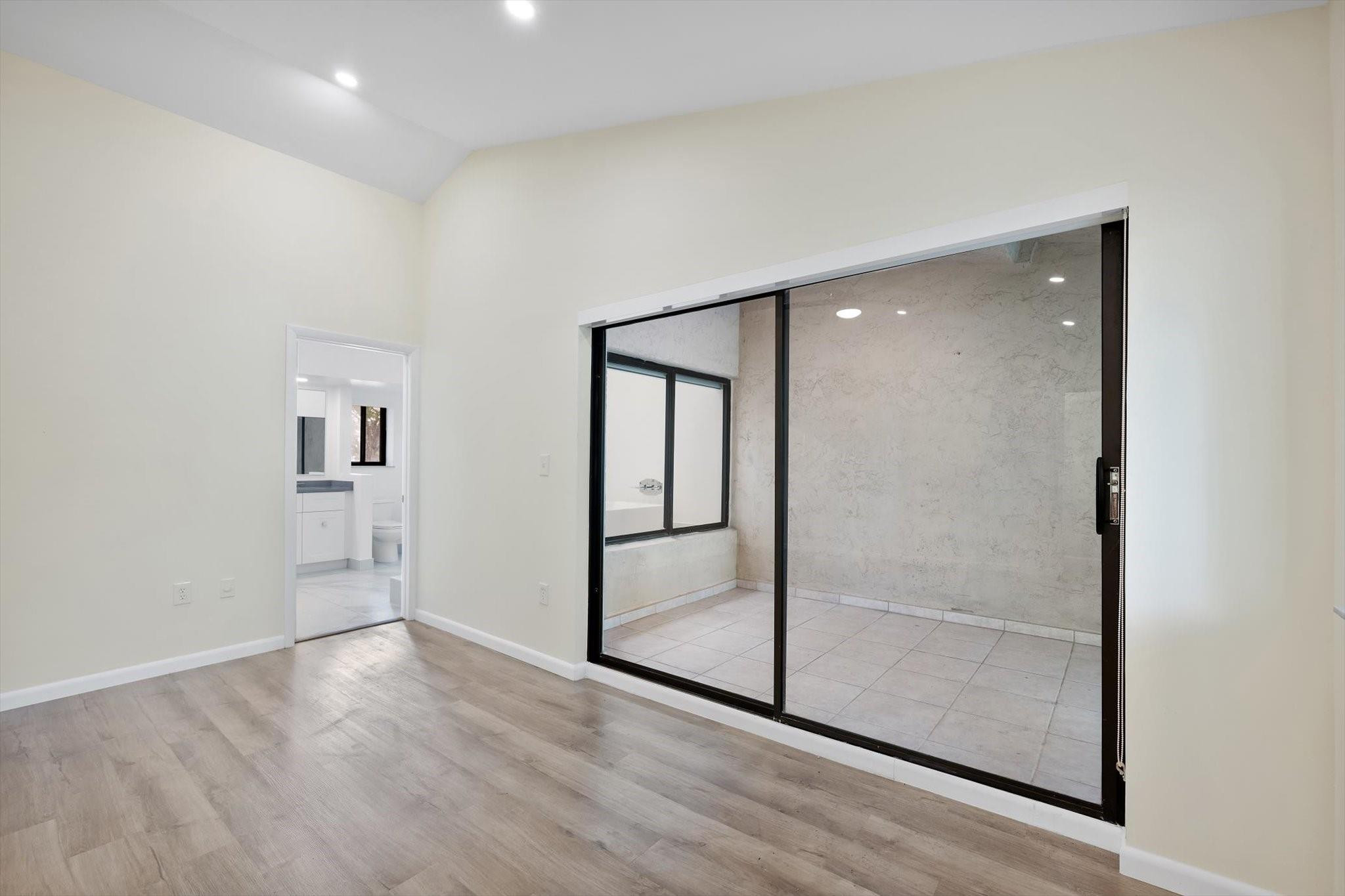 19986 Northeast 5th Court, Unit 4D Miami, FL 33179 - Photo 23 of 46 an empty room with wooden floor and mirror