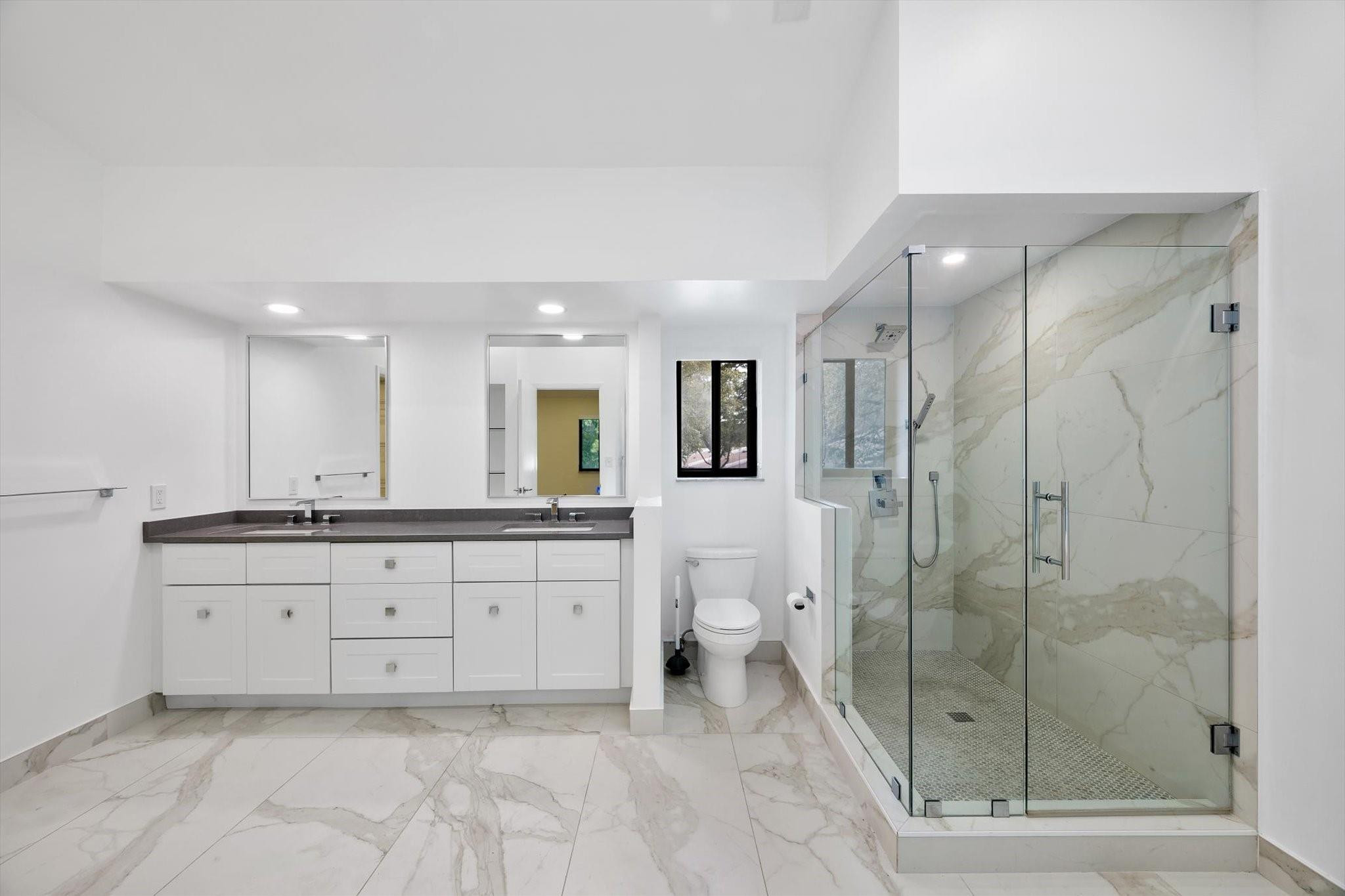 19986 Northeast 5th Court, Unit 4D Miami, FL 33179 - Photo 24 of 46 a large bathroom with a glass door shower and sink