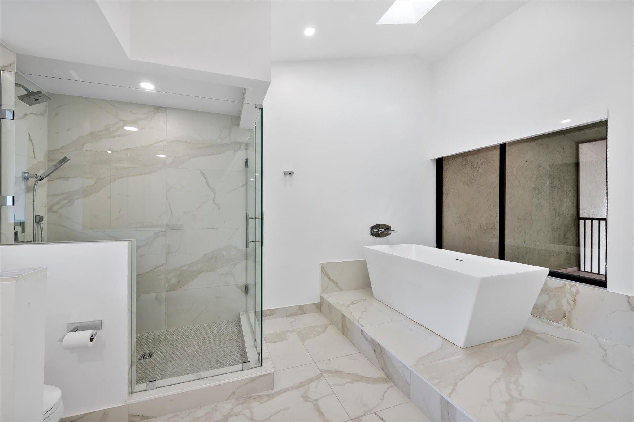 19986 Northeast 5th Court, Unit 4D Miami, FL 33179 - Photo 26 of 46 a bathroom with a tub shower and toilet