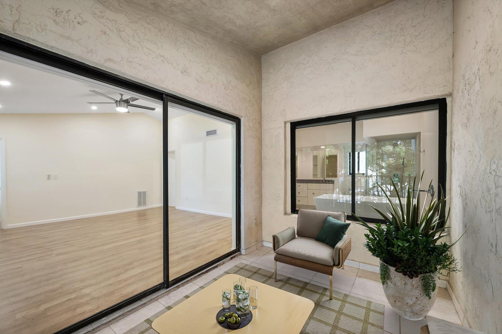 19986 Northeast 5th Court, Unit 4D Miami, FL 33179 - Photo 29 of 46 a living room with furniture and a floor to ceiling window