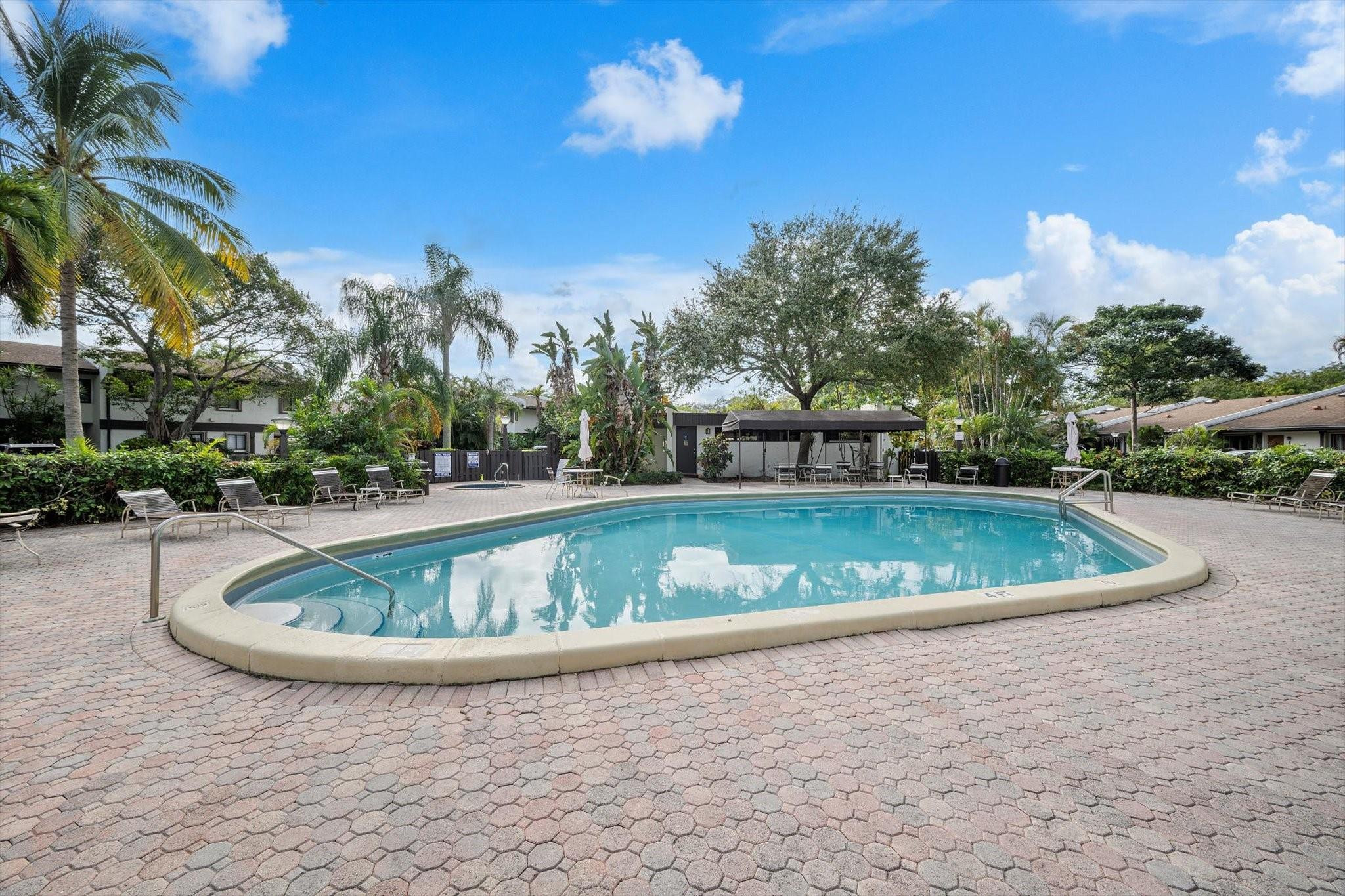 19986 Northeast 5th Court, Unit 4D Miami, FL 33179 - Photo 33 of 46 a view of a swimming pool with a yard